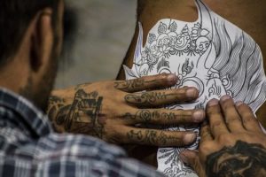 man making tattoo